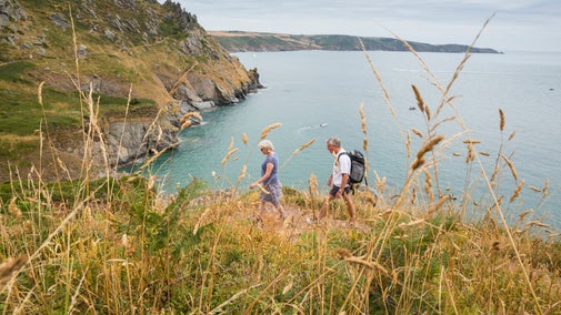Visitors walking the South West Coast Path at East Soar, Devon